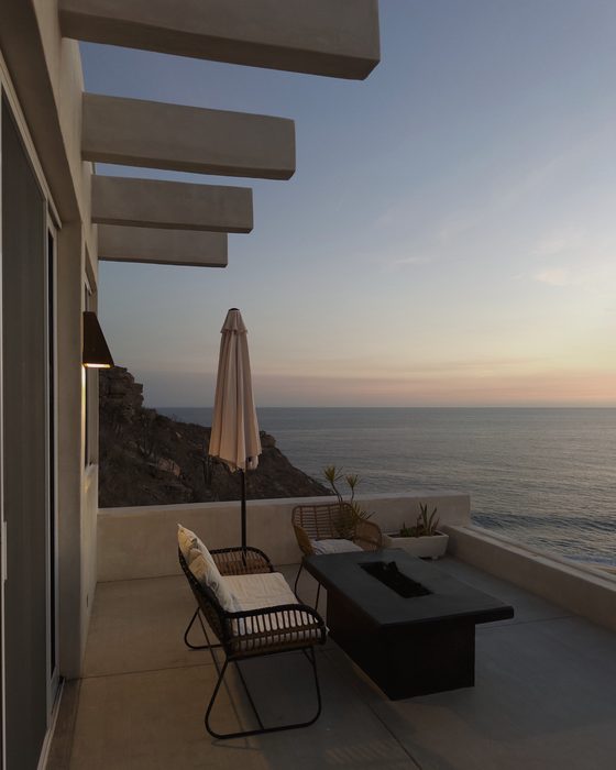 Terrace at dusk, firepit lit, open to the Pacific