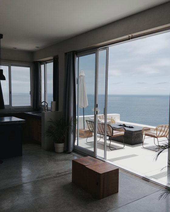 Room interior looking out to the terrace and sea